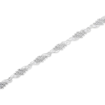 White metal bracelet with alternating clusters of round pave-set white gemstones and links featuring channel-set baguette white gemstones, shown in a diagonal top-down close-up view.