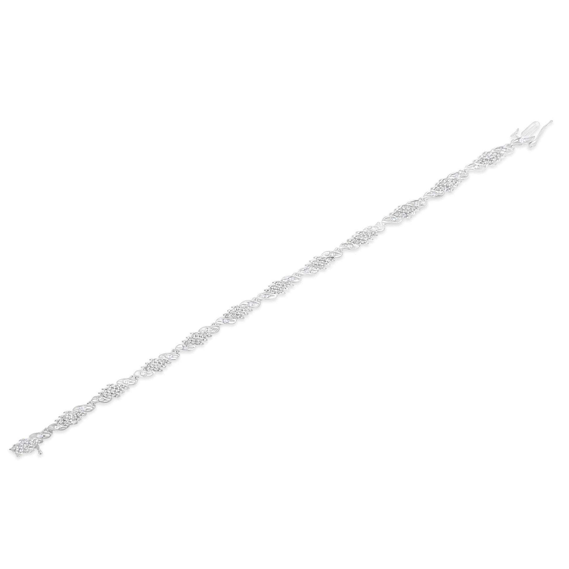 White metal bracelet with an alternating pattern of round white gemstones in pave setting and baguette white gemstones in channel setting, shown at a slight angled top-down view on a white background.