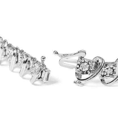 Close-up angled view of a white metal bracelet with two types of round white gemstones in miracle and prong settings, featuring a clasp detail.