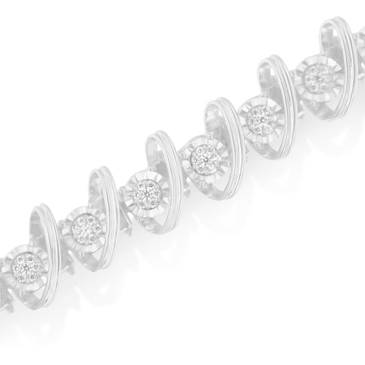 Close-up angled view of a white metal bracelet featuring round white gemstones in miracle and prong settings arranged in circular patterns along the chain.