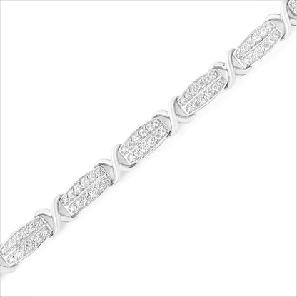 Diagonal close-up of a white bracelet featuring alternating rectangular links with pave-set round white gemstones and smooth curved links.