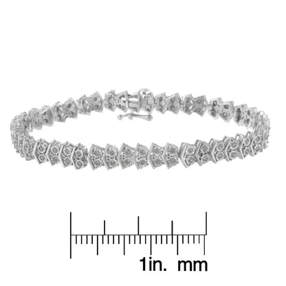 White metal bracelet with round white gemstones in miracle setting, shown in a side angled view, placed above a ruler for size reference.