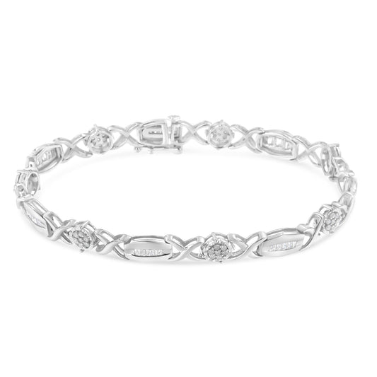 White metal bracelet with alternating sections of round pave-set white gemstones and baguette channel-set white gemstones, shown in a top down angle on a white background.