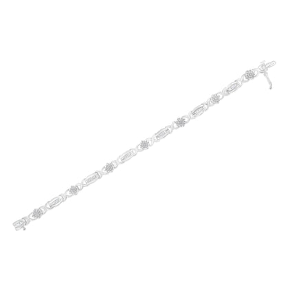White metal bracelet with alternating round white gemstones in pave setting and baguette white gemstones in channel setting, shown from a top flat lay angle.