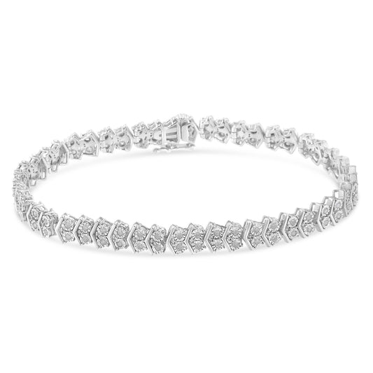 Close-up, front angle of a white metal bracelet with round white gemstones in a miracle setting along its length.