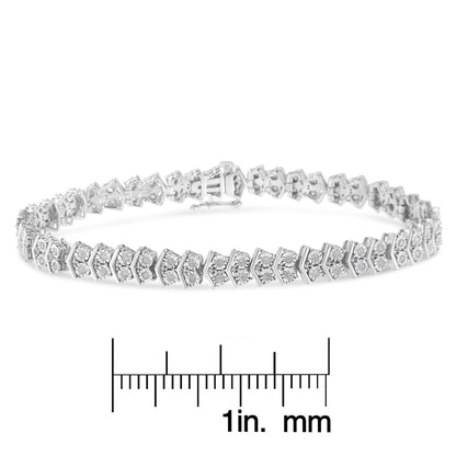White metal bracelet with round white gemstones in a miracle setting, displayed flat on a ruler for size reference, front angle shot.