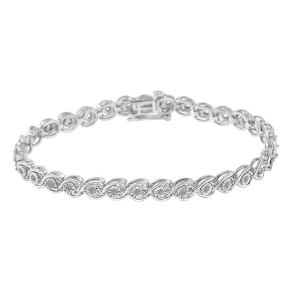 White metal bracelet with round white gemstones in a miracle setting, shown in a slightly angled top-down view.