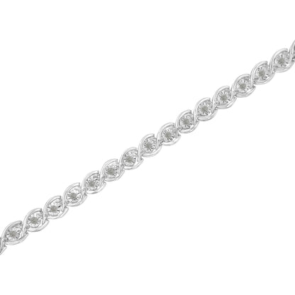 Diagonal close-up of a white bracelet featuring round white gemstones in a miracle setting.