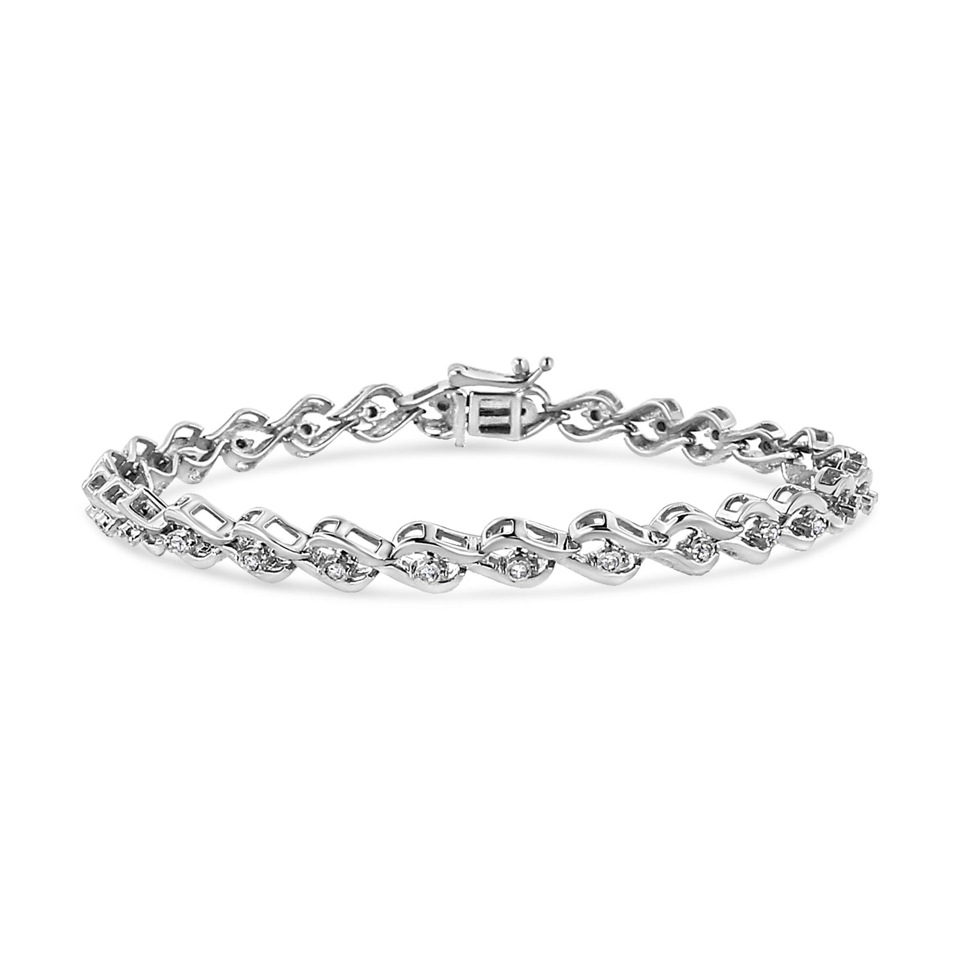 White metal bracelet with round white gemstones in a Miracle setting, shot from a slightly angled top view.
