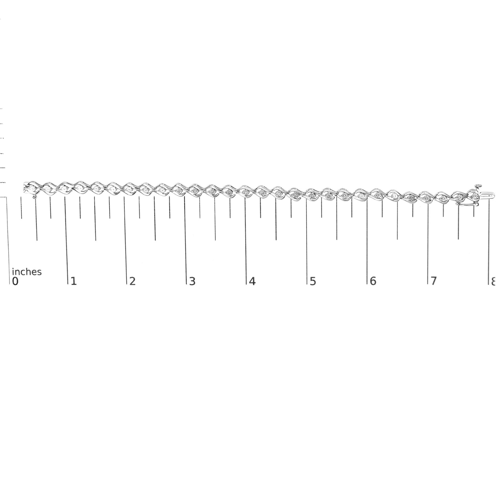 White metal bracelet with round white gemstones in miracle settings, laid flat on a ruler for size reference, shot from above.