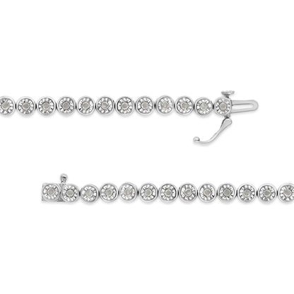 Top-down view of a white metal bracelet with round white gemstones set in a continuous line, shown with clasp open.
