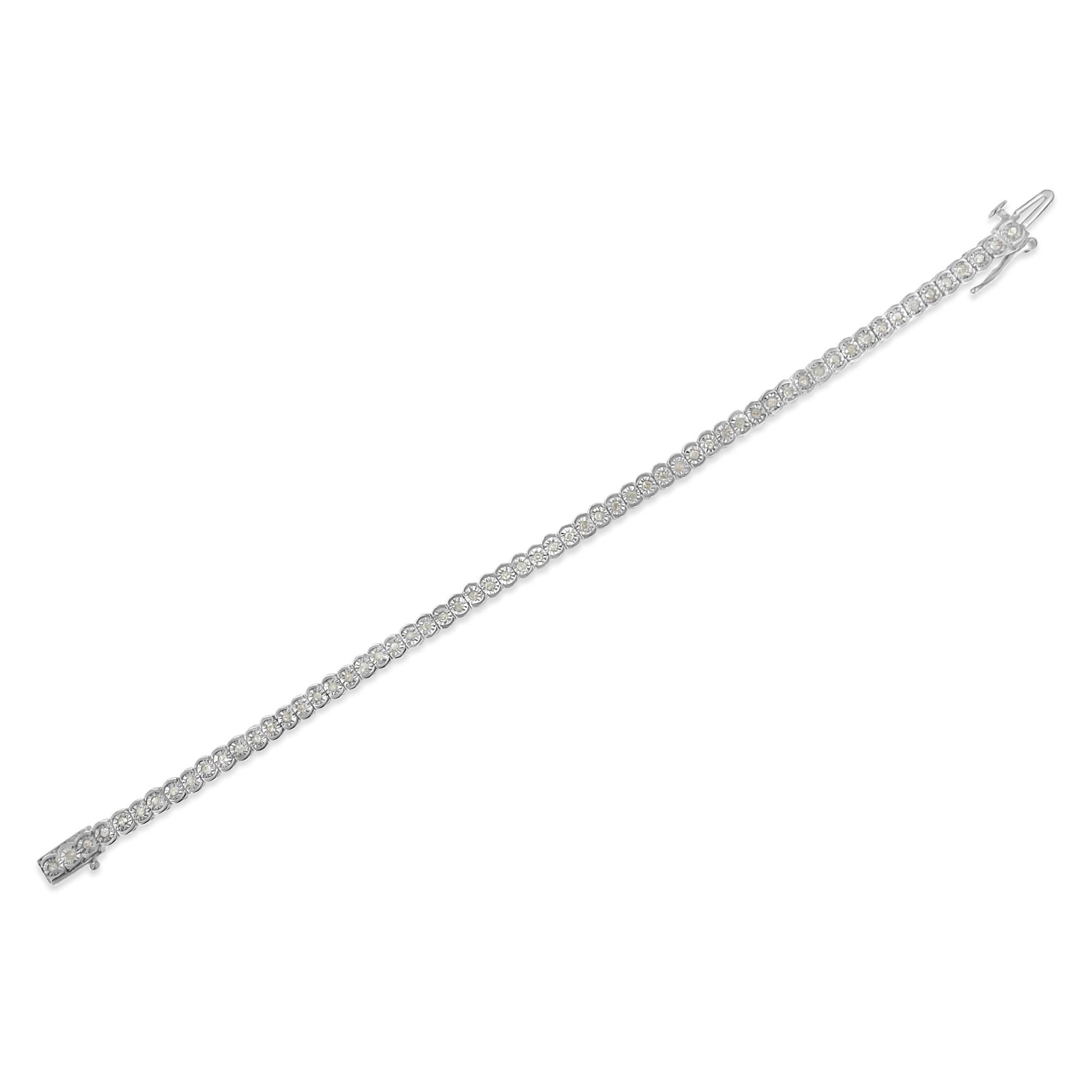 Diagonal top-down view of a white bracelet with round white gemstones set along its length.