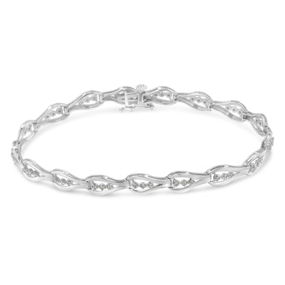 White metal bracelet with alternating open links featuring round white gemstones in prong settings, shown from a top angled view.