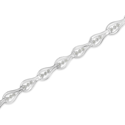 White metal bracelet with repeating linked teardrop shapes, each set with round white gemstones in prong settings, shown in a diagonal close-up view.