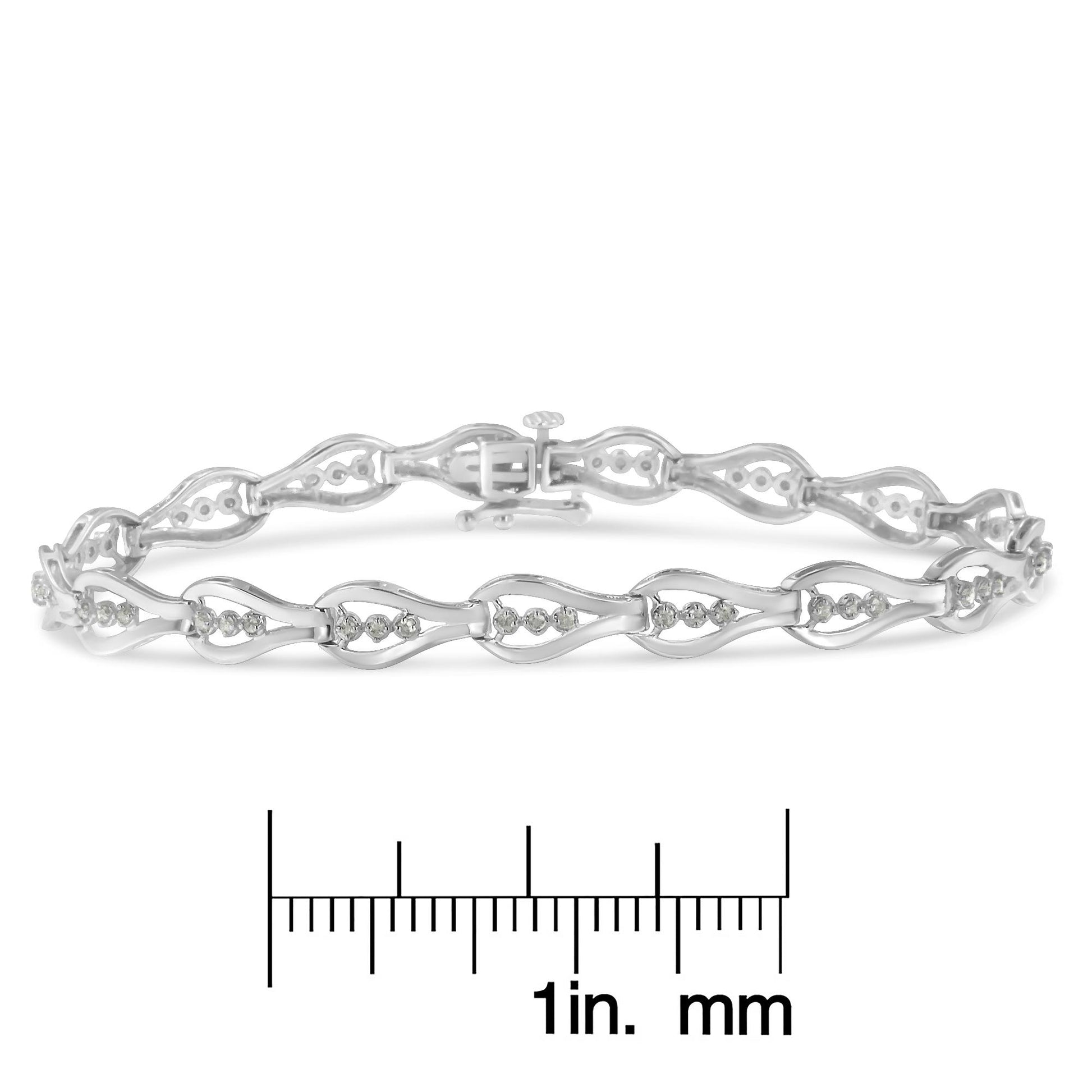 White metal bracelet with round white gemstones in prong settings, shown from a front angle on a ruler for size reference.
