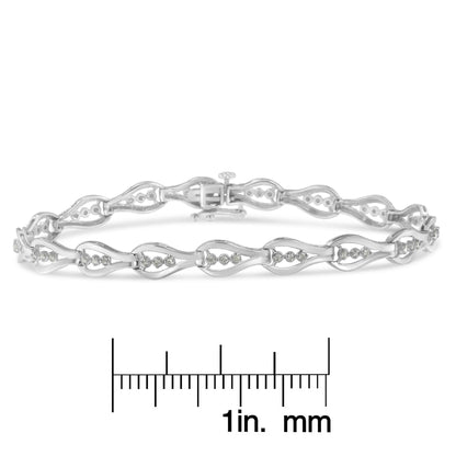 White metal bracelet with round white gemstones in prong settings, shown from a front angle on a ruler for size reference.