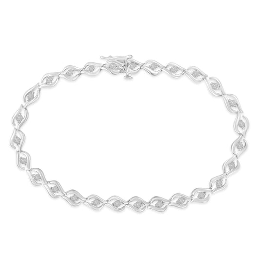 Top-down view of a white metal bracelet with a linked swirl design, each link set with a round white gemstone in prong settings.