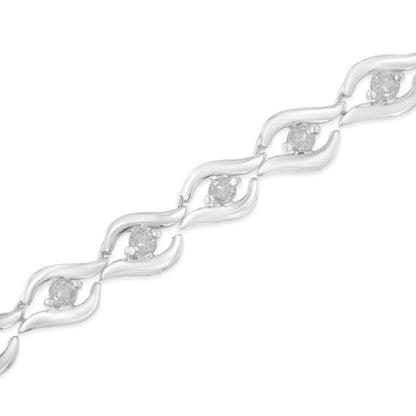 Diagonal close-up of a white metal bracelet with round white gemstones set in prong settings, featuring an open leaf-like link design.