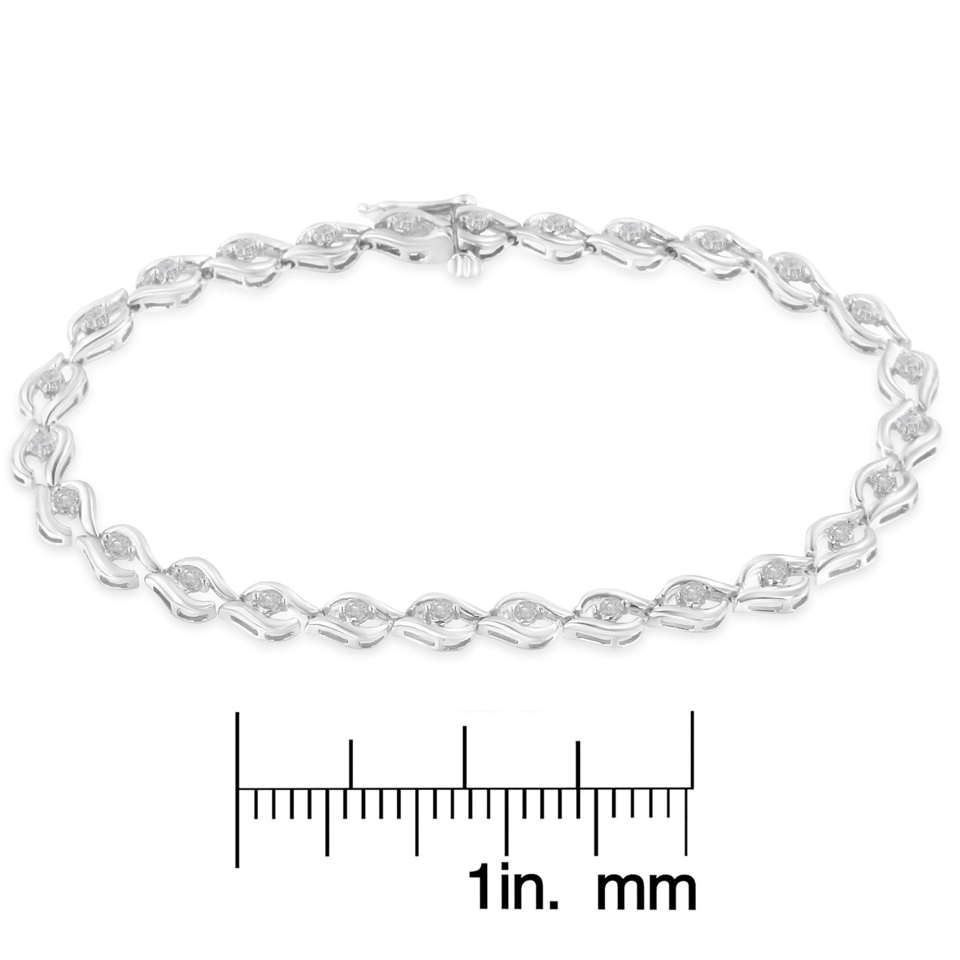 White metal bracelet with round white gemstones in prong settings, shown on a ruler for size reference, photographed from above.