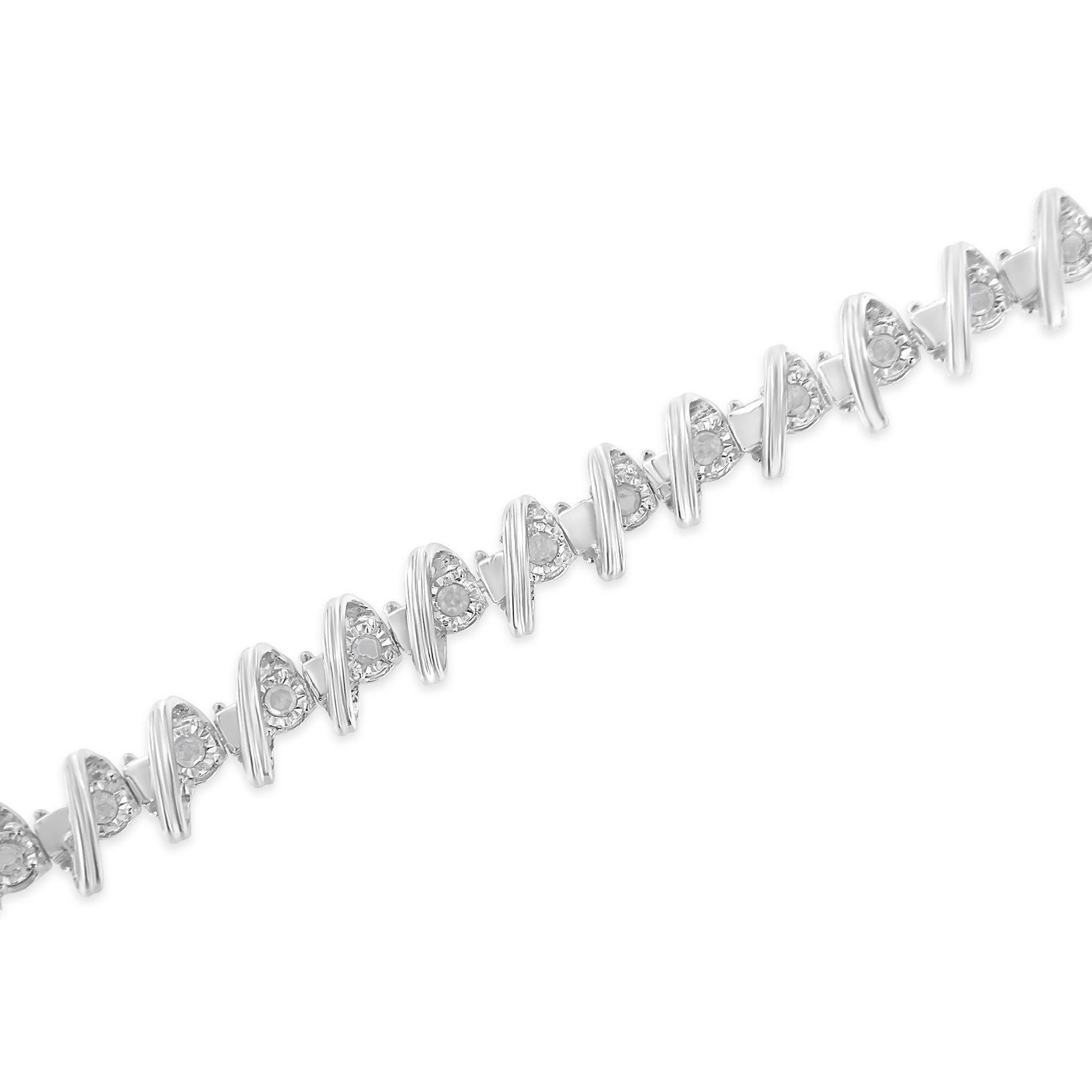 Diagonal close-up of a white metal bracelet with alternating round white gemstones in a miracle setting and curved metal accents.
