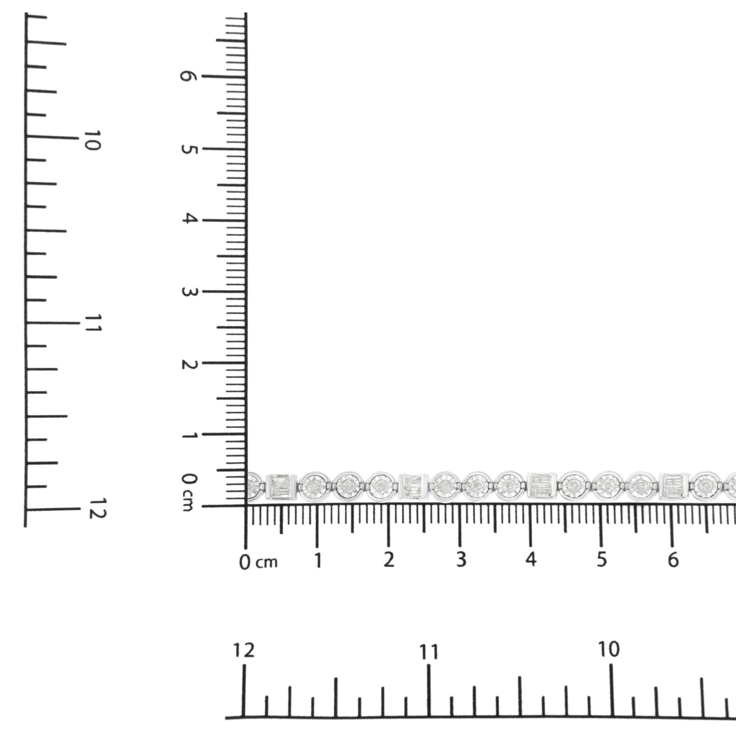 White bracelet with alternating round and baguette white gemstones, shown in a close-up top-down view on a ruler for size reference.