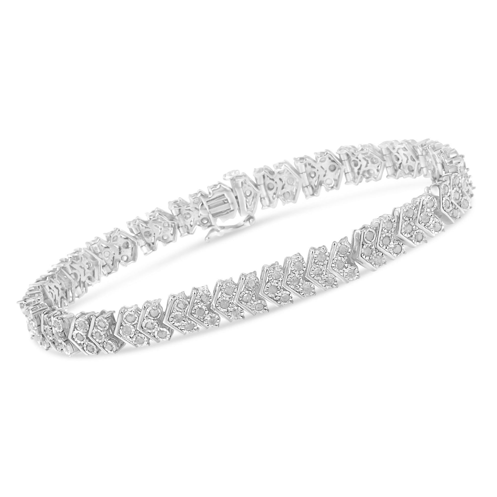 White metal bracelet with a chevron pattern set with round white gemstones, shown from a side angle.
