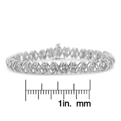 White metal bracelet with round white gemstones in a crisscross pattern, shown from the front on a ruler for size reference.