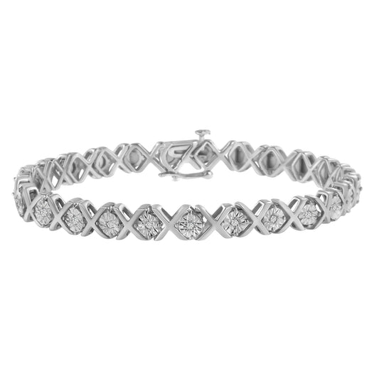 White metal bracelet with an alternating X and round setting design featuring round white gemstones, shot from a front angle against a white background.