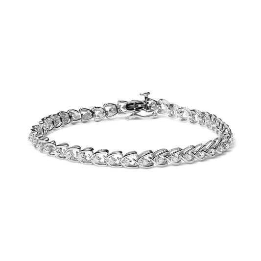 White metal bracelet with round white gemstones in prong settings, shown from a side angle on a white background.