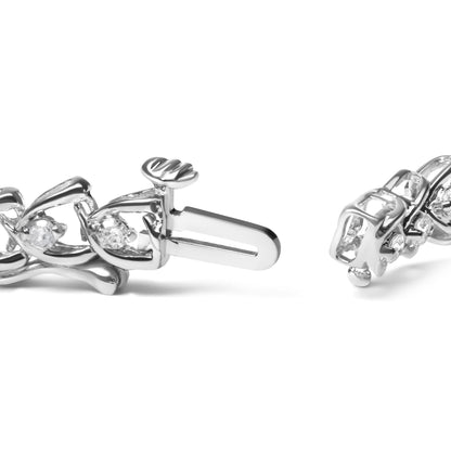 Close-up angled view of a white metal bracelet with round white gemstones in prong settings, showing the clasp mechanism.