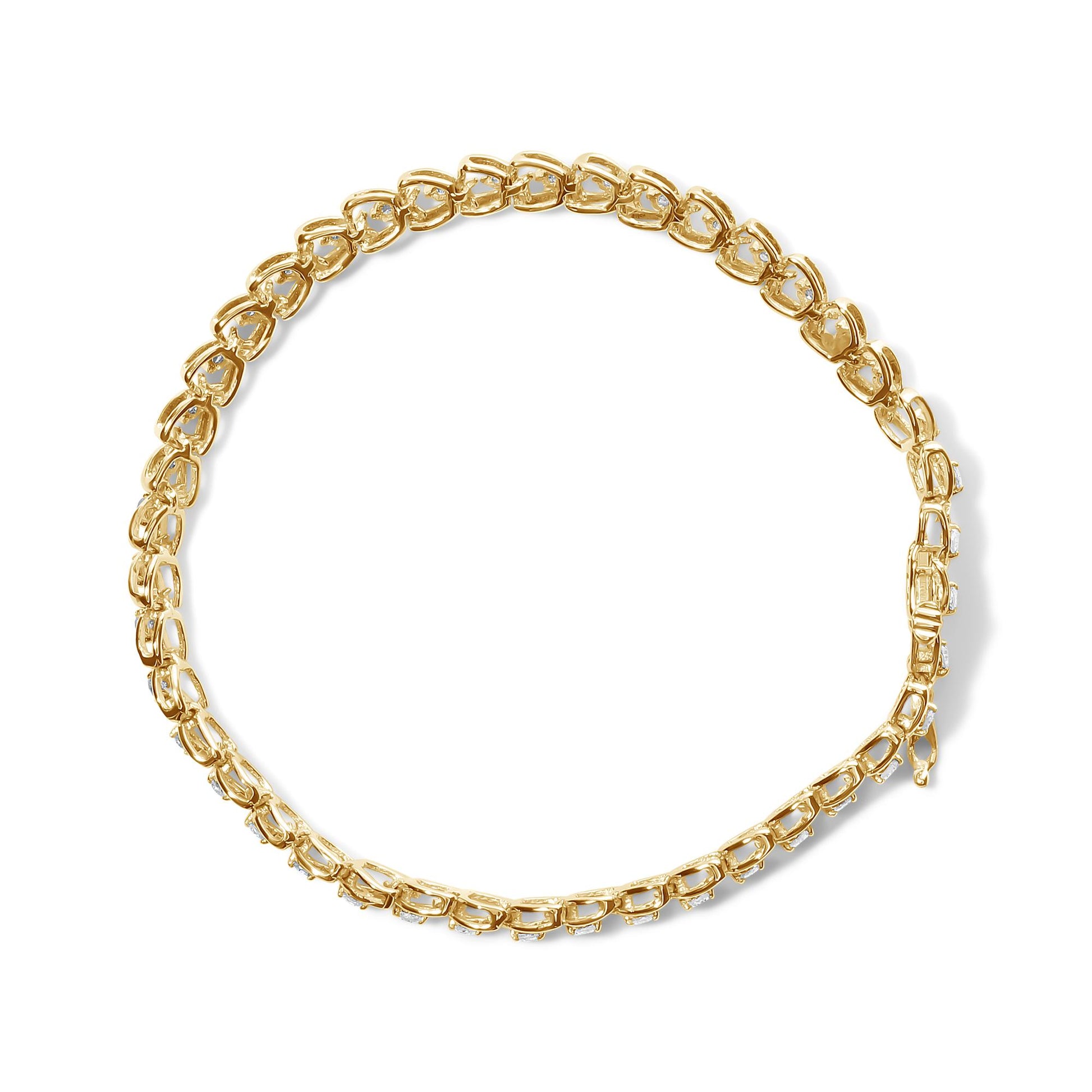 Top-down view of a yellow metal bracelet with round white gemstones in prong settings along the links.