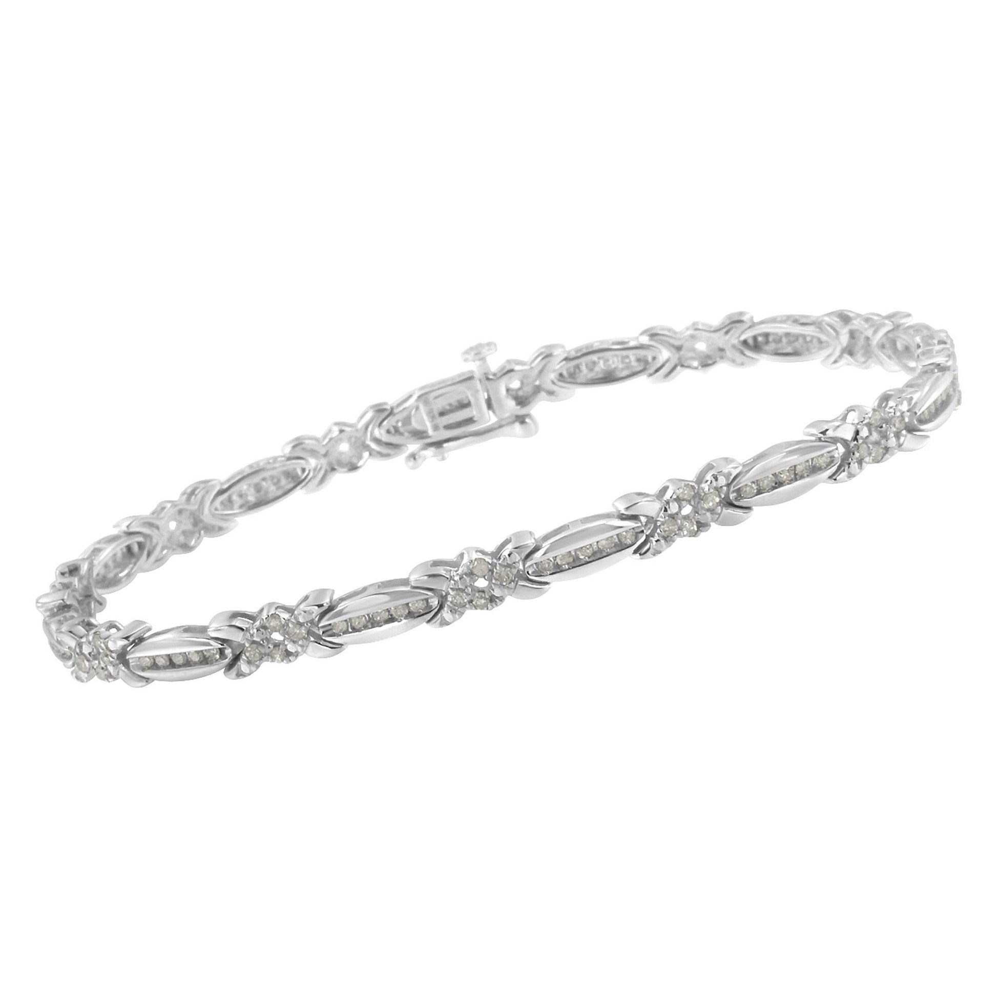 White metal bracelet with alternating elongated oval and flower-shaped links, each set with small white gemstones in a pave setting, shown in a side angle view.