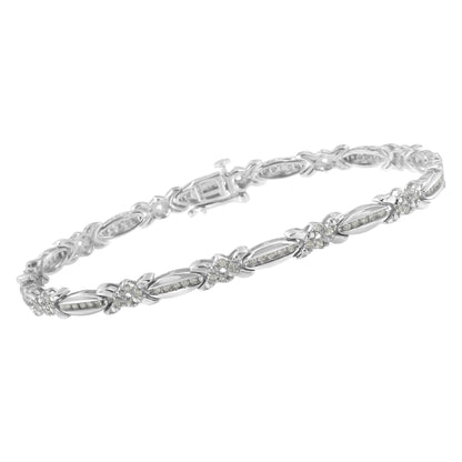 White metal bracelet with alternating elongated oval and flower-shaped links, each set with small white gemstones in a pave setting, shown in a side angle view.