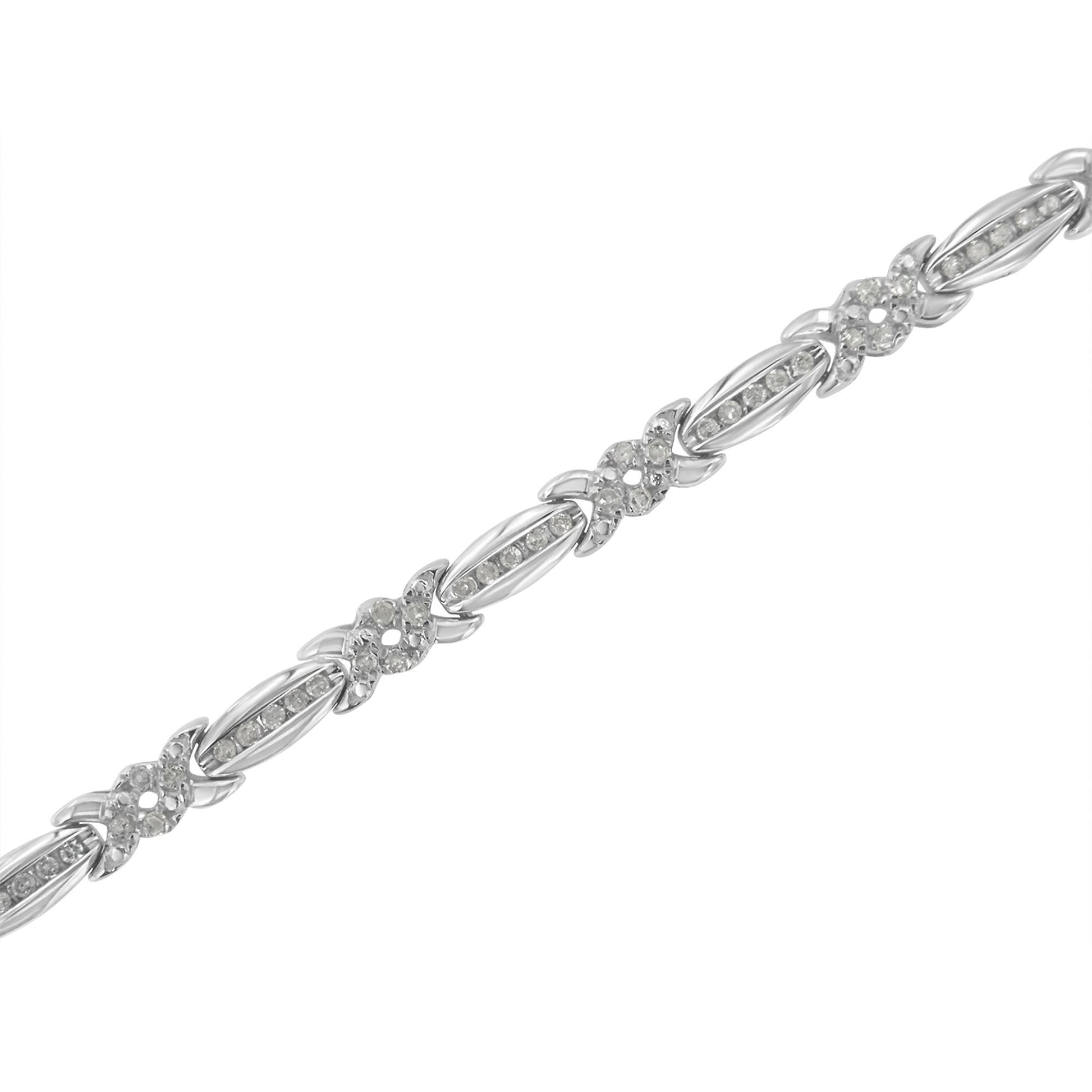 White metal bracelet with alternating oval and flower-shaped links set with round white gemstones in pave setting, shown at a diagonal angle.