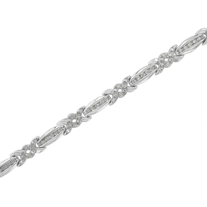 White metal bracelet with alternating oval and flower-shaped links set with round white gemstones in pave setting, shown at a diagonal angle.