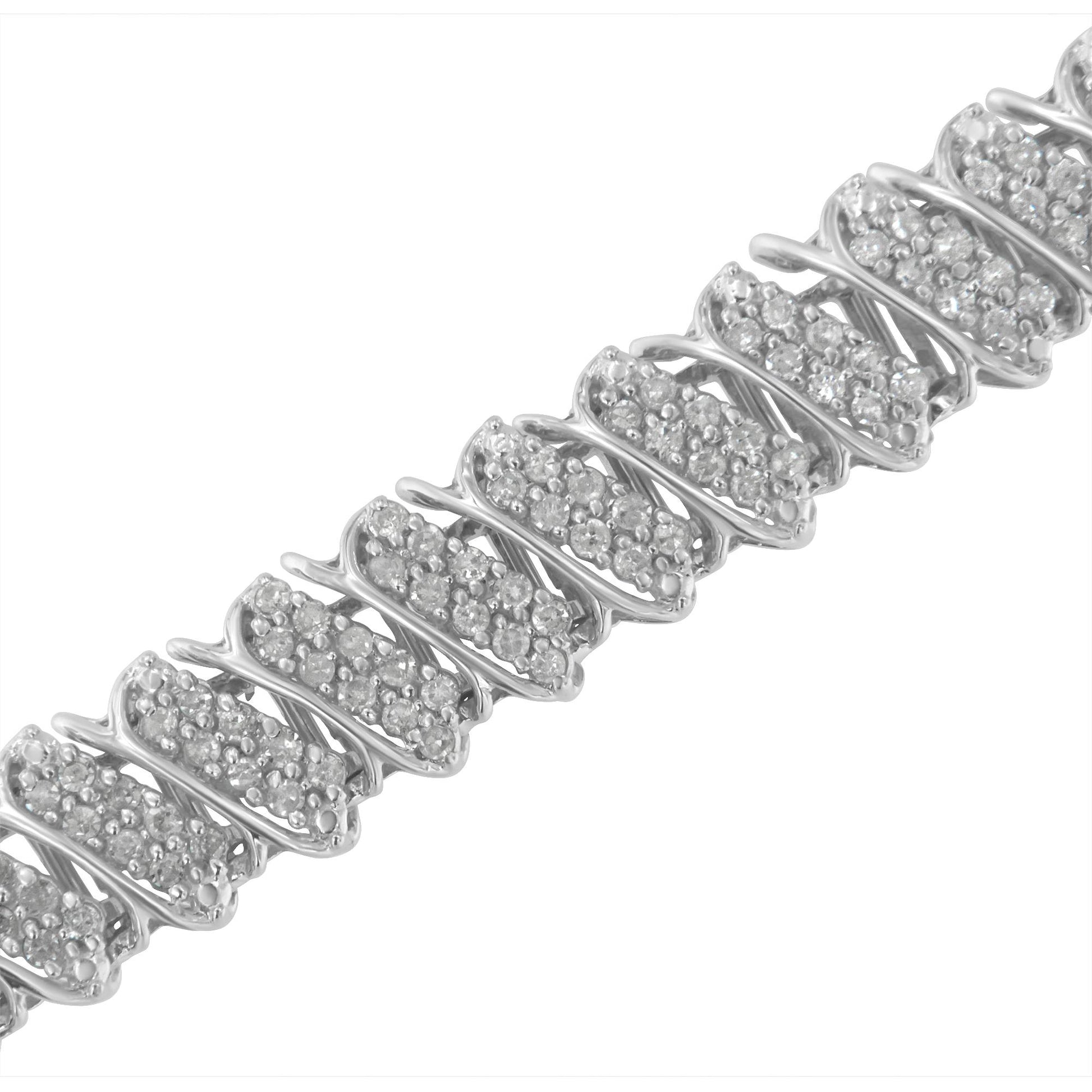 Close-up diagonal top-down view of a white metal bracelet with multiple rectangular sections featuring round white gemstones in a pave setting.