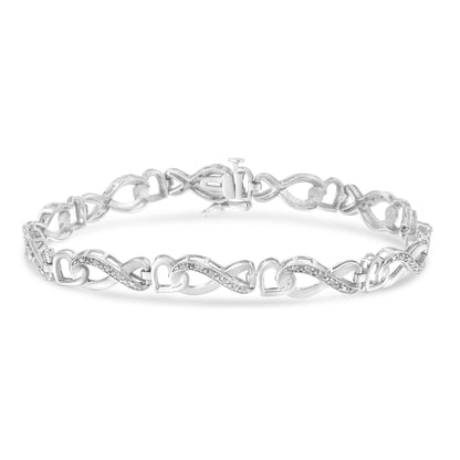 White metal bracelet with alternating heart and infinity links accented with round pave-set white gemstones, shown from a slightly angled front view.