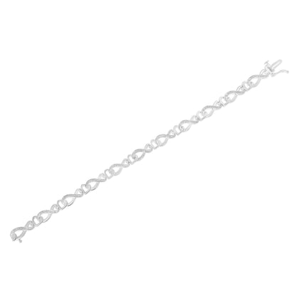 White metal bracelet with alternating heart and infinity-shaped links, each infinity link set with small white gemstones in a pave setting, shown in a flat lay angled view.