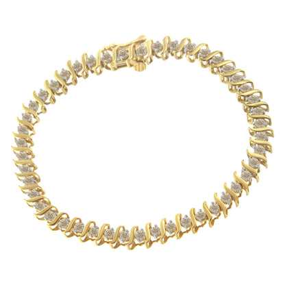 Yellow metal bracelet with round white gemstones in prong settings viewed from above.