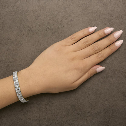 Yellow bracelet with multiple rows of round white gemstones in shared prong setting, shown worn on model’s wrist from above angle.