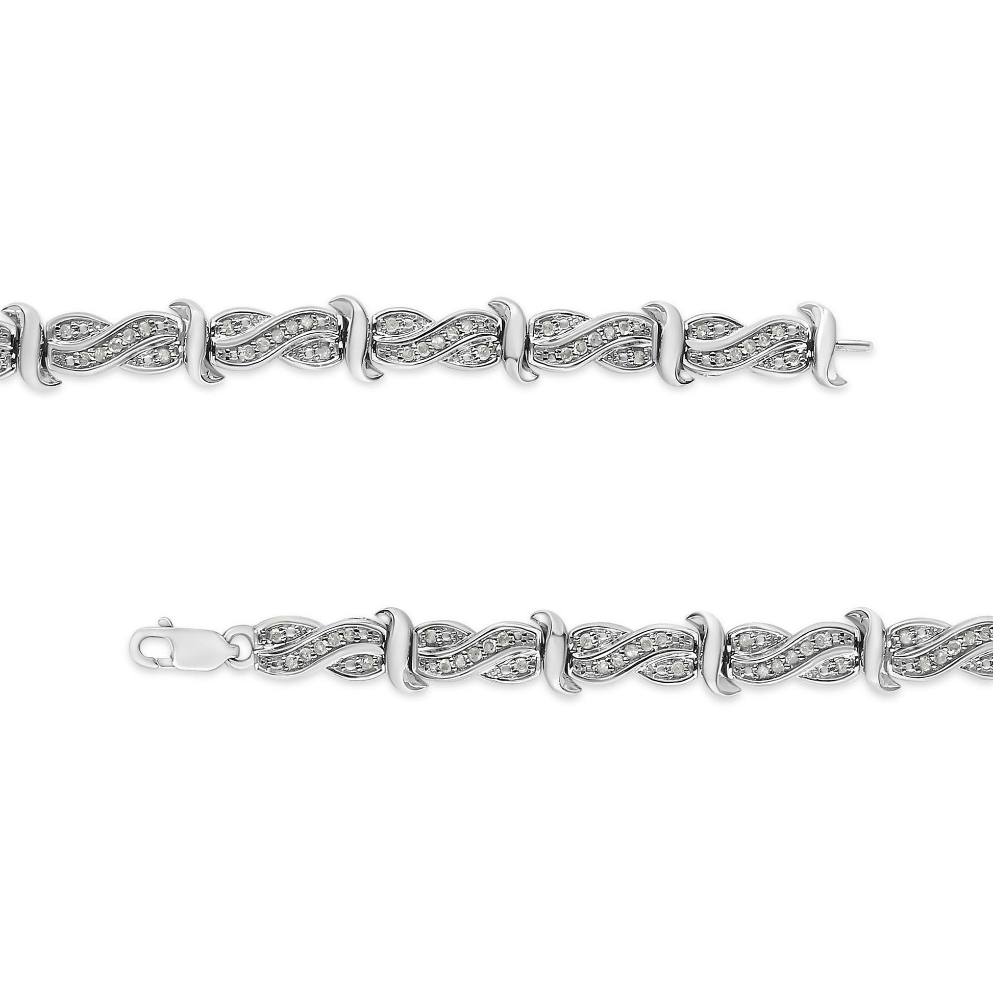 Top-down view of a white metal bracelet with interlocking wave-shaped links adorned with round white gemstones in pave setting.