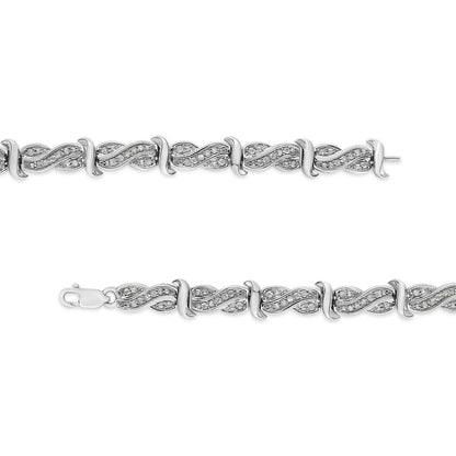 Top-down view of a white metal bracelet with interlocking wave-shaped links adorned with round white gemstones in pave setting.