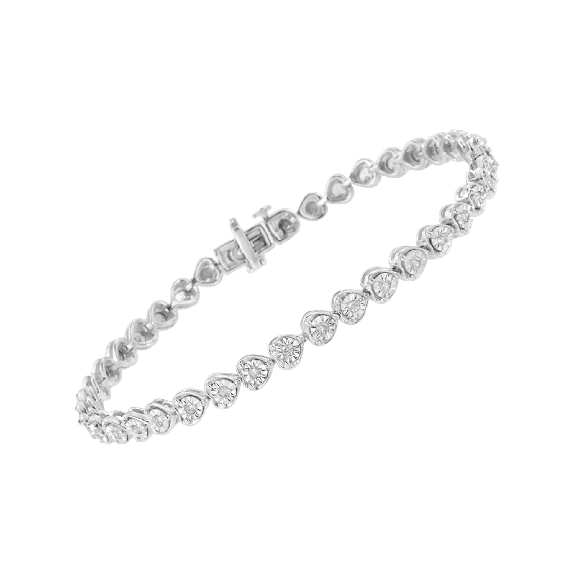 White metal bracelet with round white gemstones in heart-shaped settings, shown at an angle on a white background.