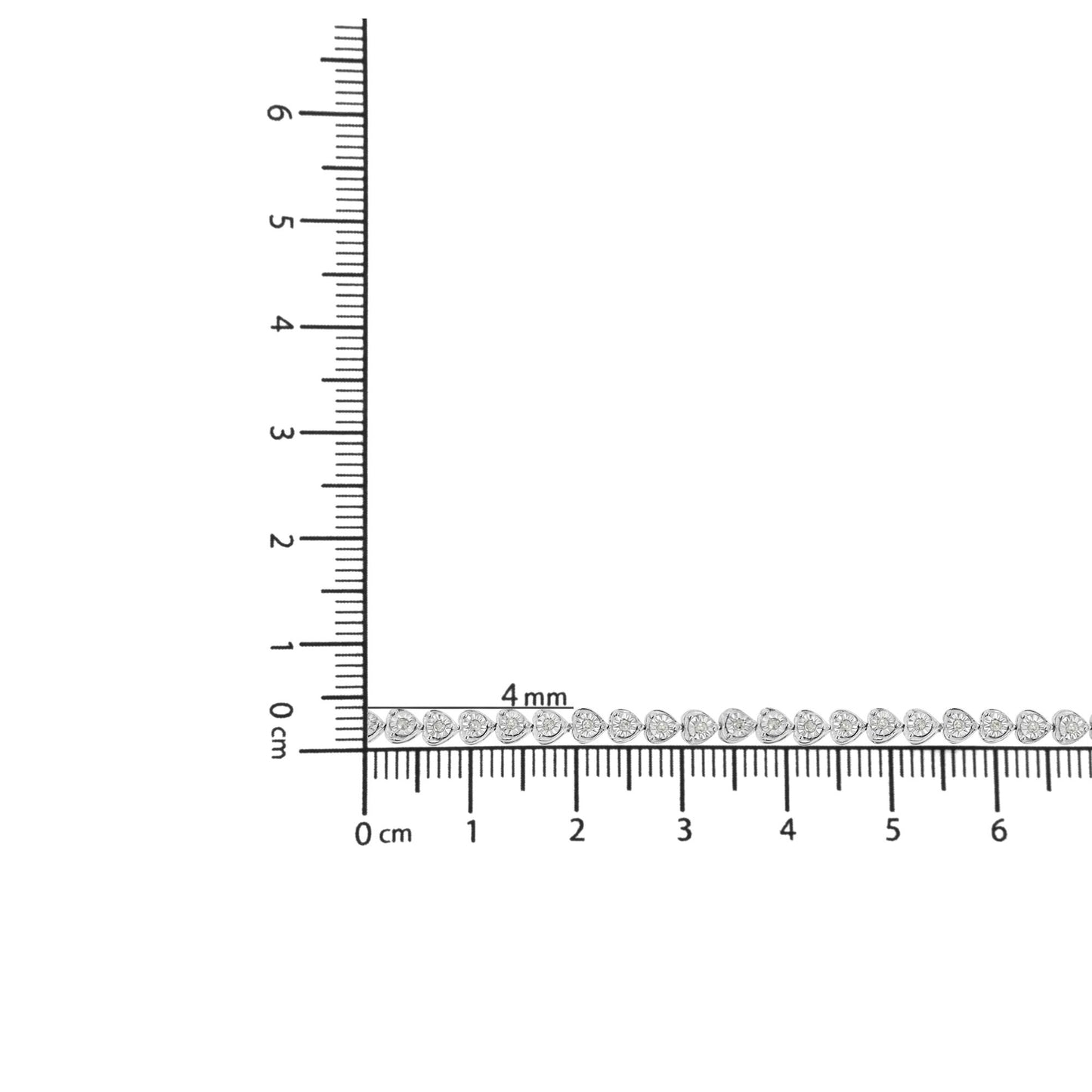 White metal bracelet with round white gemstones in miracle setting shown on a ruler for size reference, top-down angle.