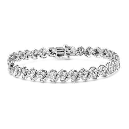 White metal bracelet with an intricate swirling design featuring round white gemstones in prong settings, shown in a front angle view.