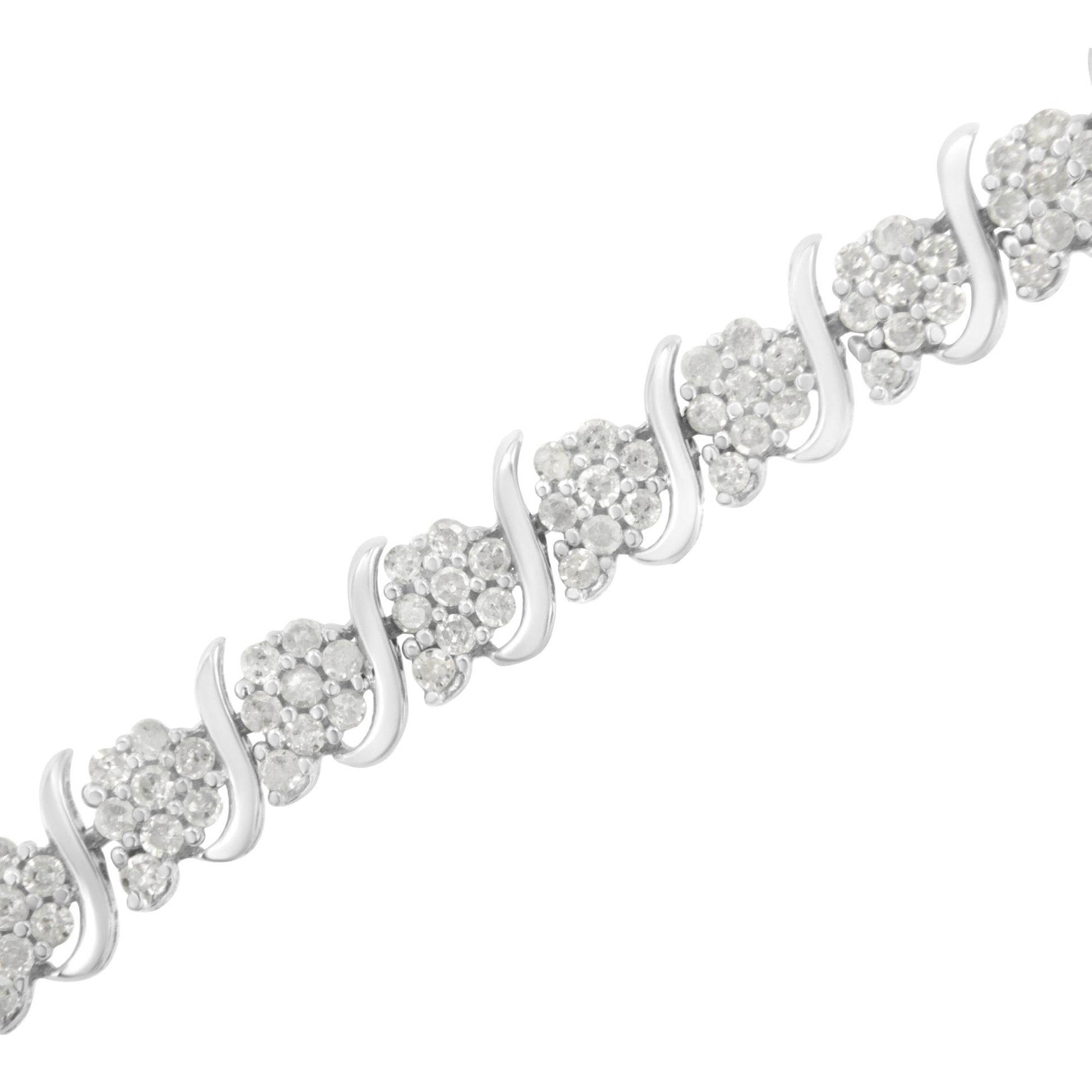 Close-up angled shot of a white metal bracelet featuring clusters of round white gemstones in prong settings alternating with smooth curved metal links.