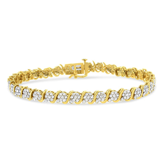 Yellow metal bracelet with alternating clusters of white round gemstones in prong settings, shown from a slight angled front view.