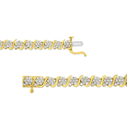 Top view of a yellow metal bracelet with clusters of white round gemstones in prong settings along its length, shown open with clasp details visible on a white background.