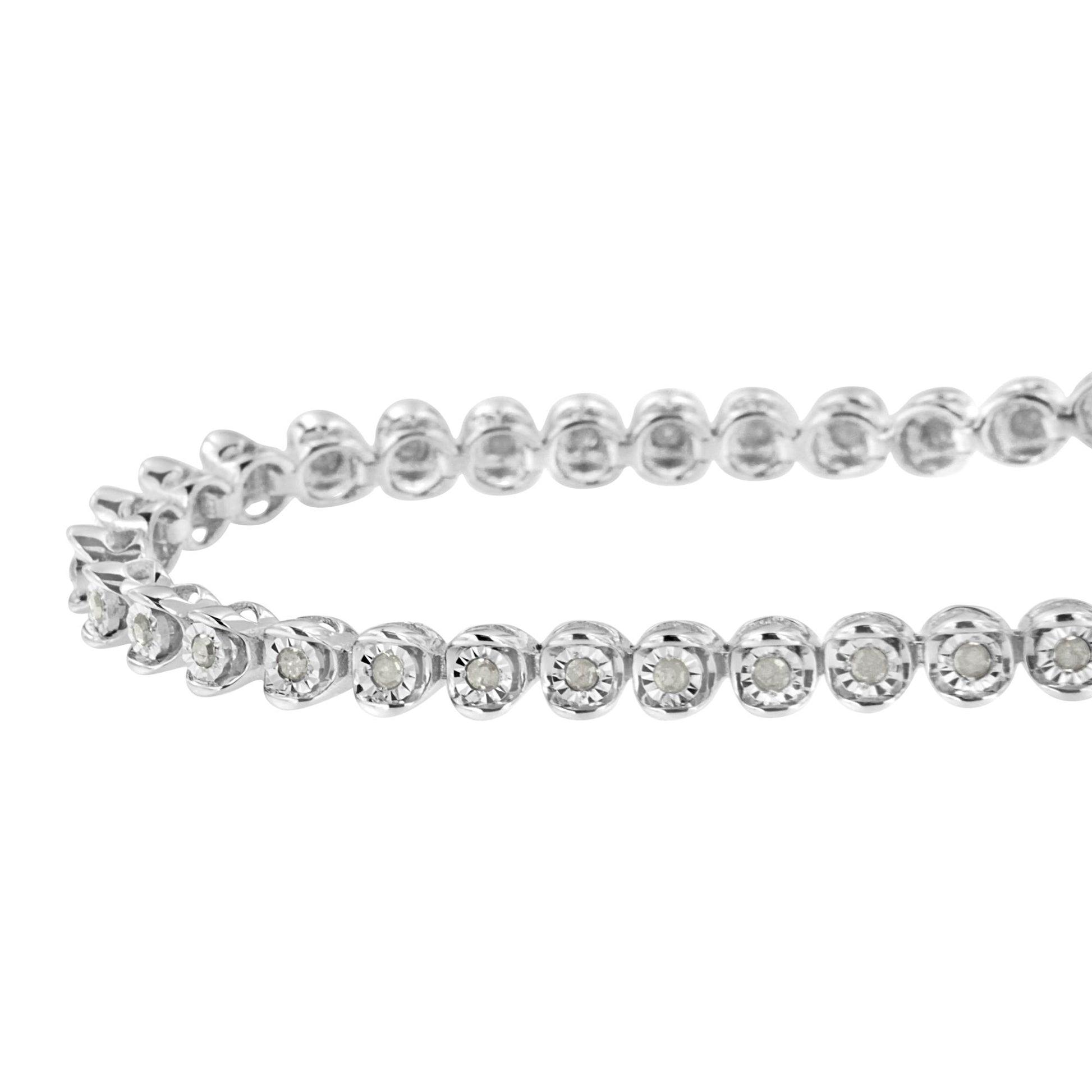 Close-up front angled view of a white metal bracelet with round white gemstones set in individual miracle settings.