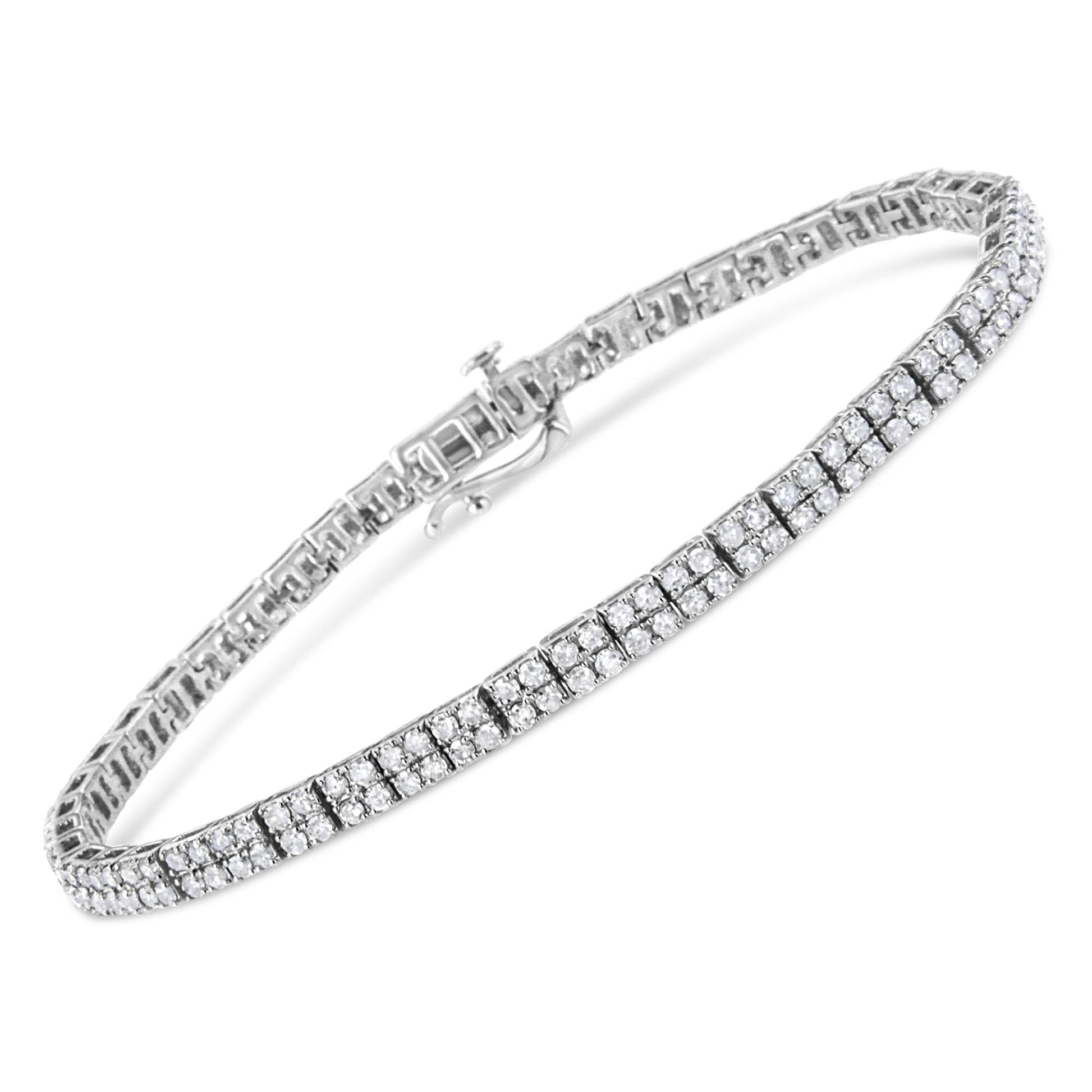 White metal bracelet with multiple rows of round white gemstones in prong settings, shown at an angled top view.